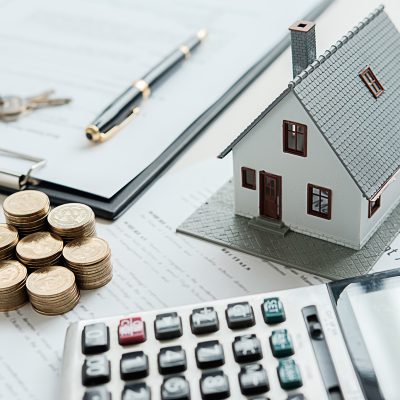 House model with real estate agent and customer discussing for contract to buy house, insurance or loan real estate background.